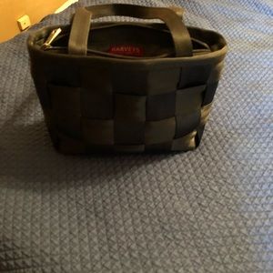 Gently used black Harvey seatbelt bag.